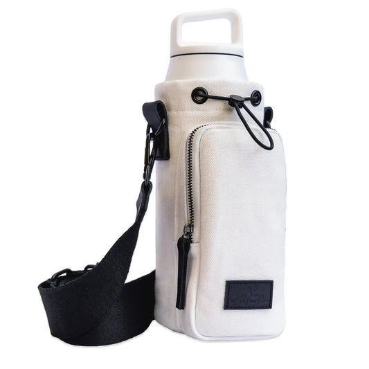 Cotton canvas and genuine leather water bottle carrier bag with crossbody strap and pocket for convenient and practical hands-free hydration on the go.